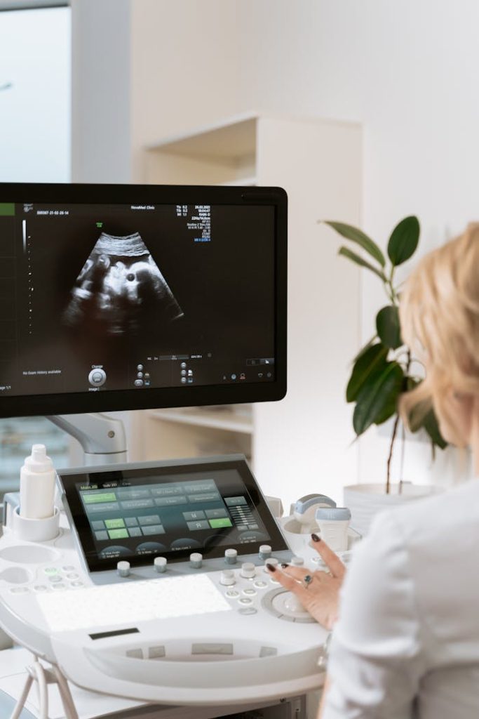 Medical professional using ultrasound equipment for patient diagnosis in a clinic.