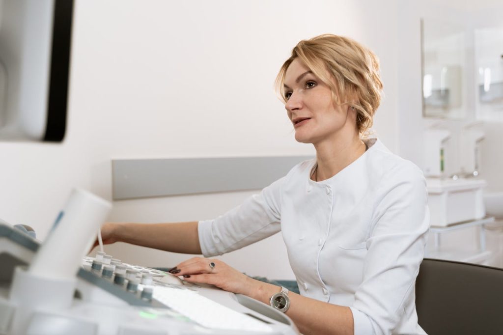 A healthcare professional using medical equipment for diagnostics in a clinical setting.